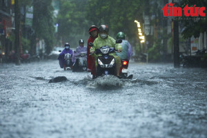 Người dân Hà Nội 'bì bõm' trở về nhà trong cơn mưa tầm tã